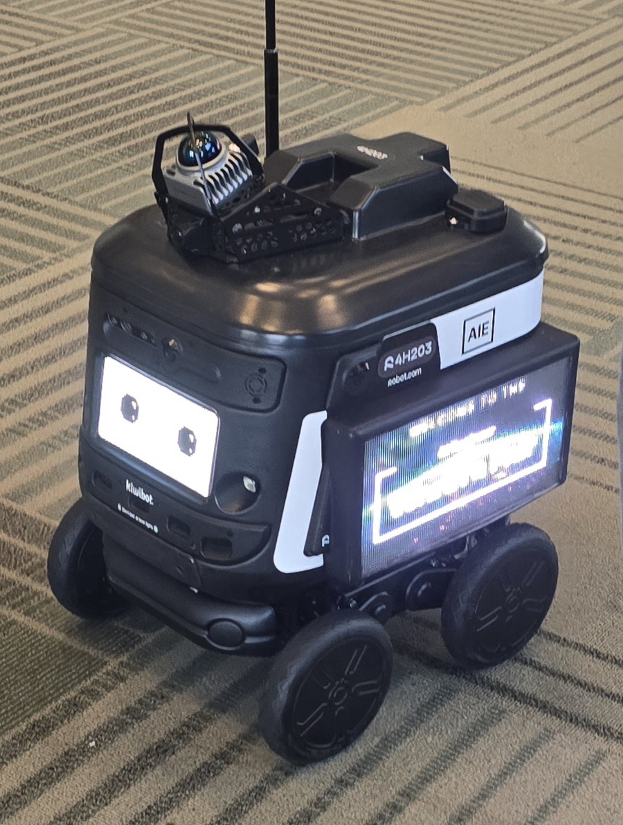 Close-up of the robot.com delivery bot's face and wheels