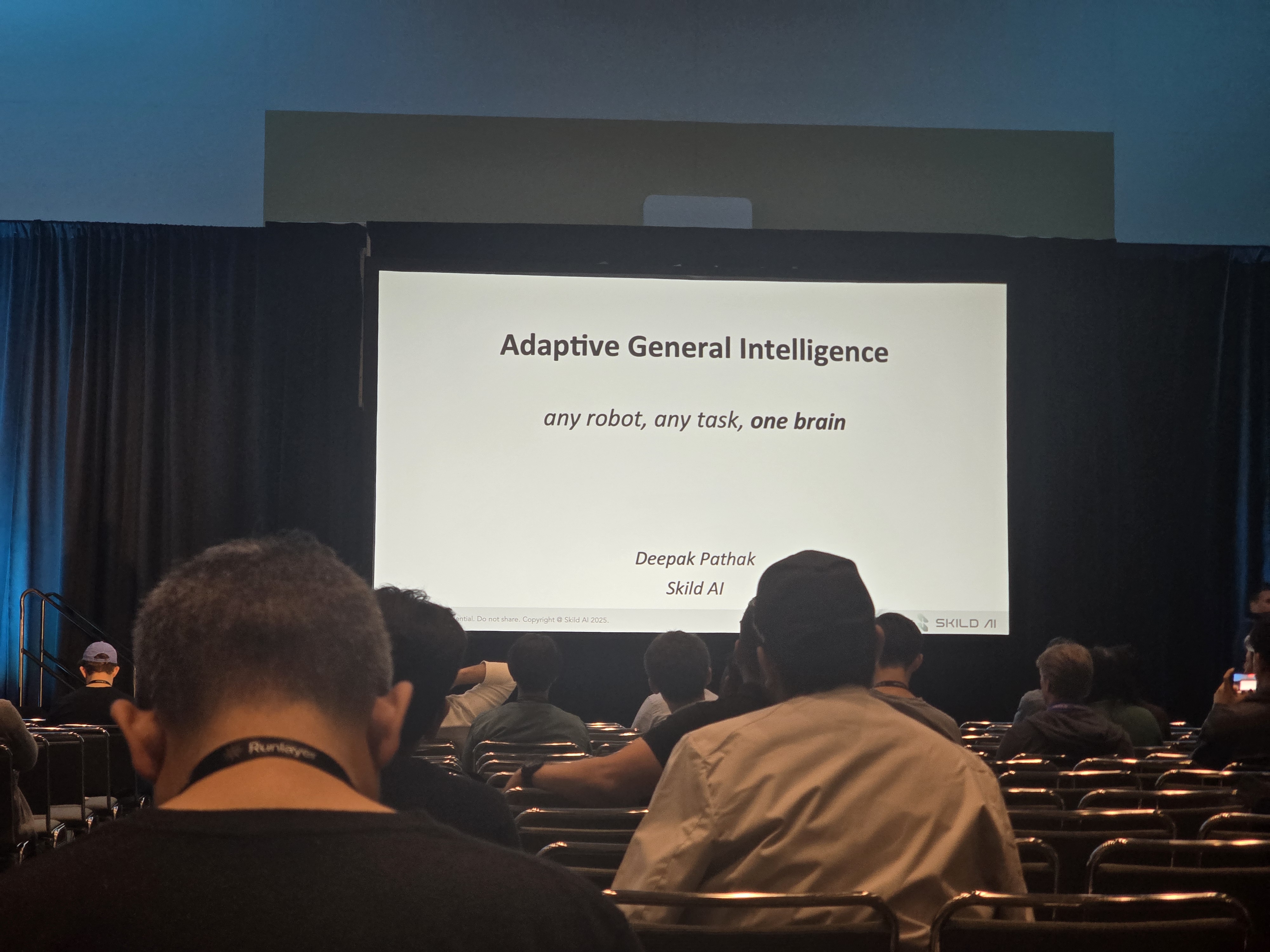 Pathak's title slide: "Adaptive General Intelligence - any robot, any task, one brain" - rest of the slides in the Conference Errata post