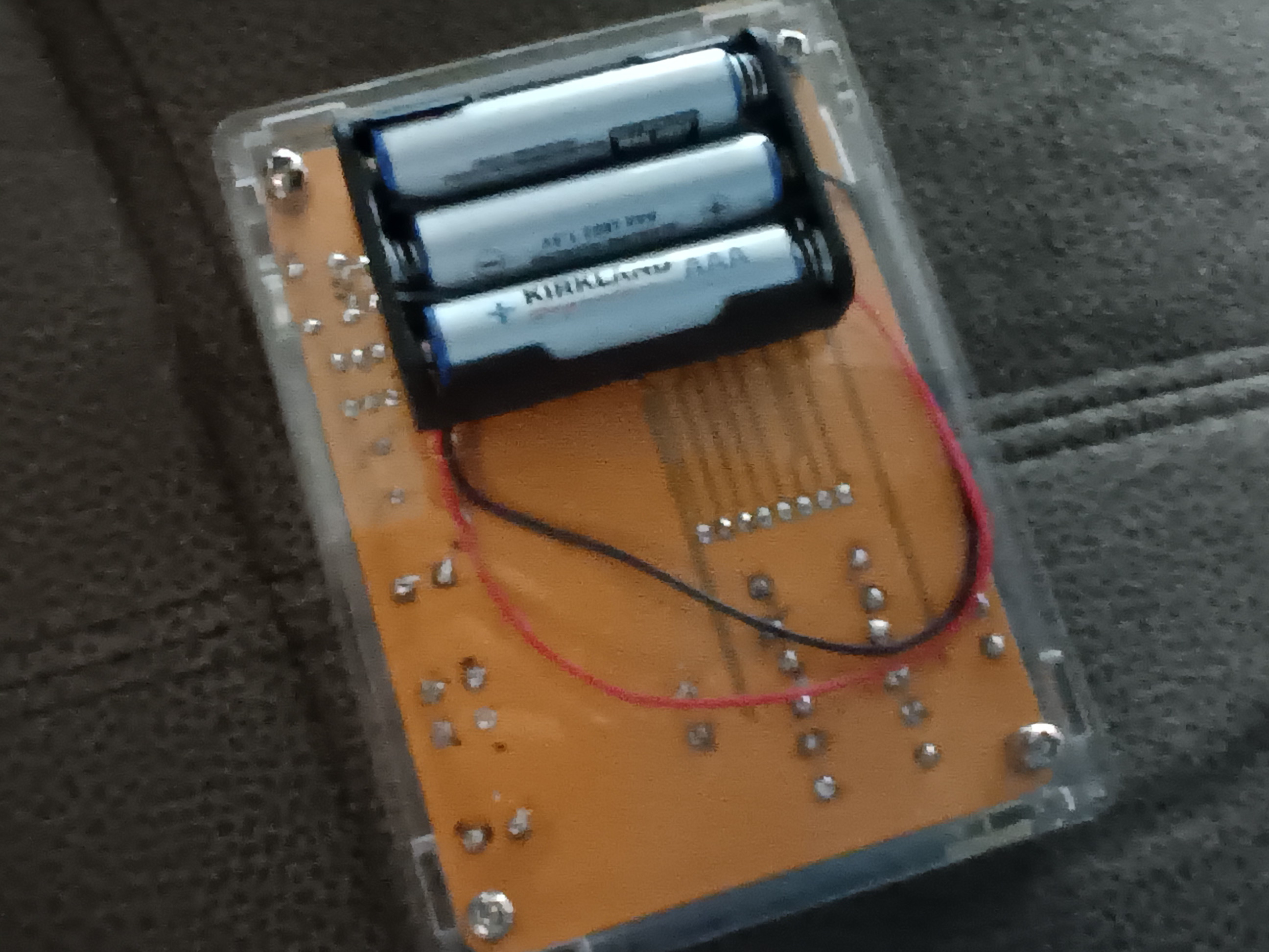 the back of the device, showing the soldered battery compartment with three AAA batteries